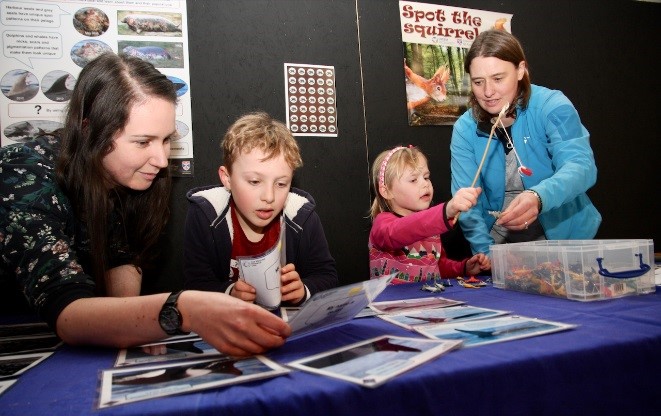 researchers and visitors talking about wildlife
