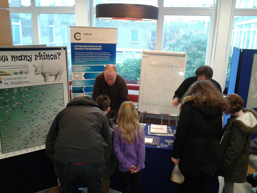 Researchers and visitors at the CREEM stand. 