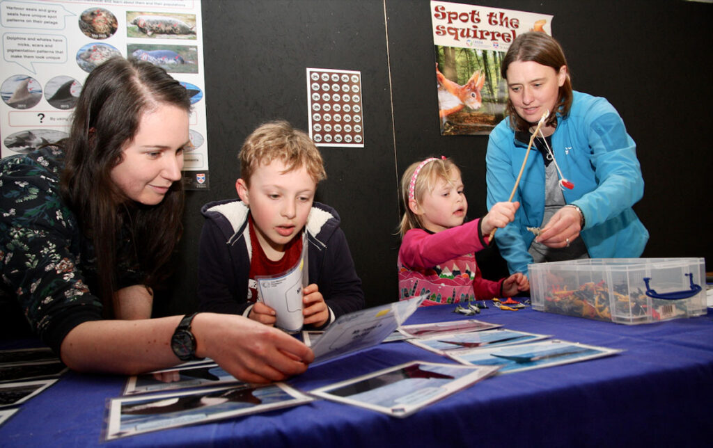 Children identifying whale features with the help of researchers. 