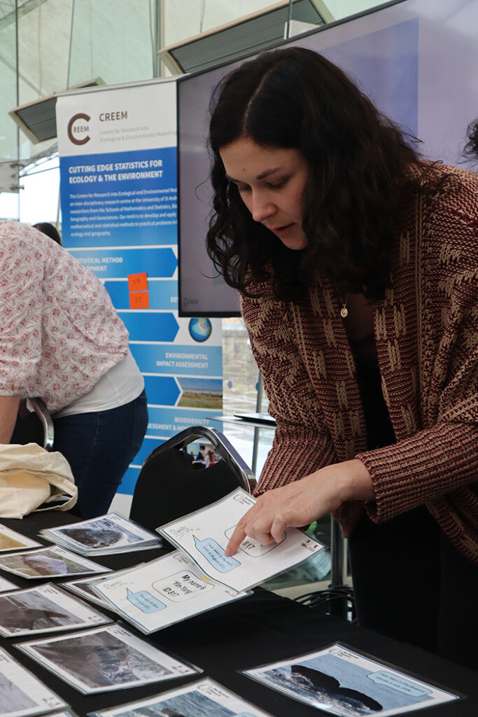 Researcher pointing to a speech bubble in a document they are holding